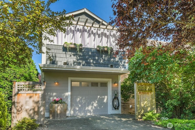4138 21st Ave SW, Seattle, WA 98106 - view of front facade with a garage, driveway, and a balcony