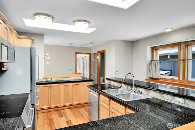 4138 21st Ave SW, Seattle, WA 98106 - kitchen with stainless steel appliances, tile countertops, light wood-style floors, and light brown cabinetry