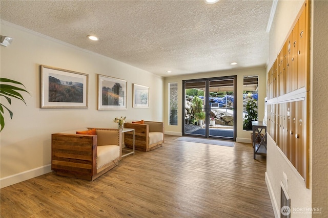 1113 5th Ave S Unit 301, Edmonds, WA 98020 - sitting room featuring a textured ceiling, wood finished floors, recessed lighting, and ornamental molding