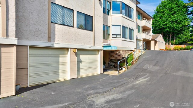 1113 5th Ave S Unit 301, Edmonds, WA 98020 - view of building exterior with an attached garage and driveway