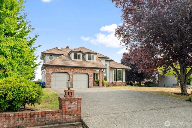 19724 Island Pkwy E, Lake Tapps, WA 98391 - view of front facade featuring asphalt driveway, a tile roof, a garage, and brick siding