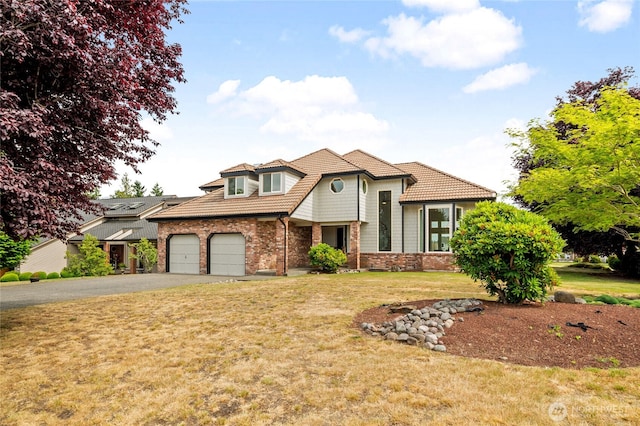 19724 Island Pkwy E, Lake Tapps, WA 98391 - view of front of house featuring asphalt driveway, a tiled roof, a garage, and a front yard