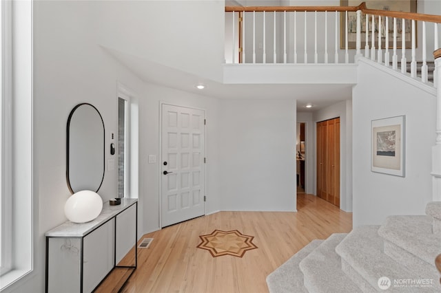 19724 Island Pkwy E, Lake Tapps, WA 98391 - foyer entrance with stairs, light wood-style floors, a high ceiling, and recessed lighting