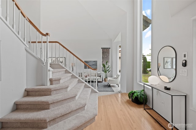 19724 Island Pkwy E, Lake Tapps, WA 98391 - entrance foyer featuring a towering ceiling, plenty of natural light, stairway, and wood finished floors