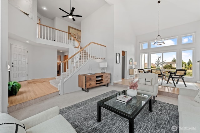 19724 Island Pkwy E, Lake Tapps, WA 98391 - carpeted living area featuring high vaulted ceiling, stairway, a chandelier, ceiling fan, and recessed lighting