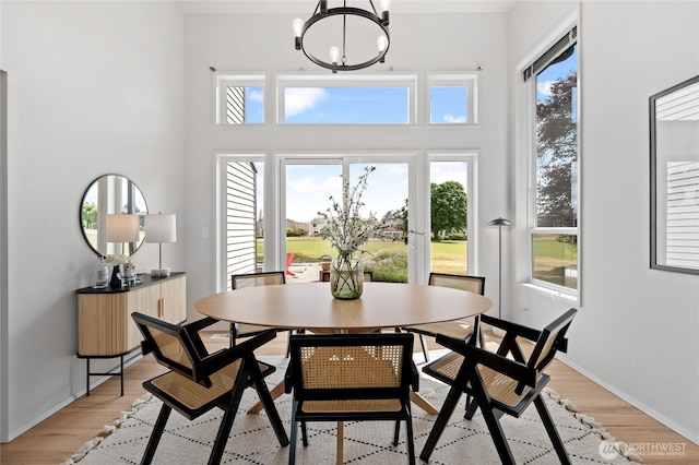 19724 Island Pkwy E, Lake Tapps, WA 98391 - dining room featuring a chandelier and light wood-style flooring