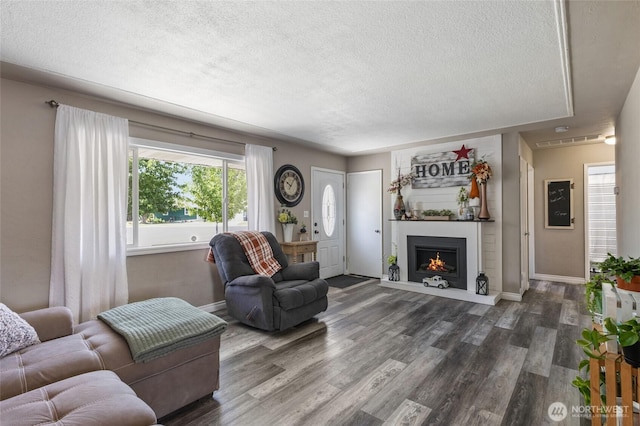 863 N Vista Dr, Moses Lake, WA 98837 - living area with a textured ceiling, wood finished floors, and a fireplace