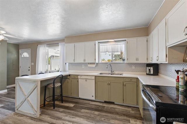 863 N Vista Dr, Moses Lake, WA 98837 - kitchen featuring white dishwasher, range with electric stovetop, plenty of natural light, and dark wood-type flooring