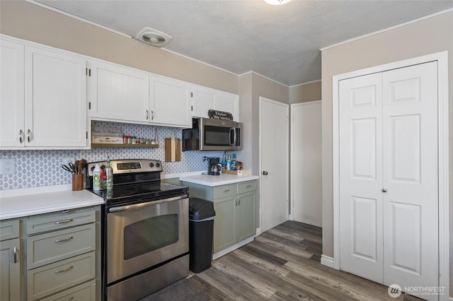 863 N Vista Dr, Moses Lake, WA 98837 - kitchen featuring stainless steel appliances, backsplash, light countertops, dark wood finished floors, and white cabinets