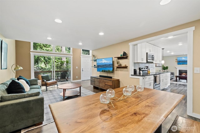 17627 17th Dr SE, Bothell, WA 98012 - dining space with wood finished floors, recessed lighting, and a warm lit fireplace