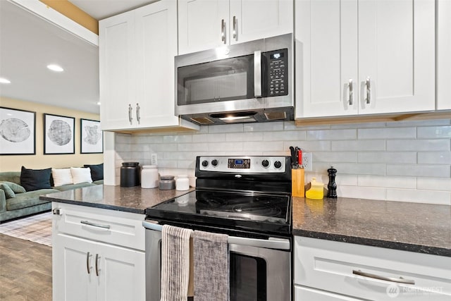 17627 17th Dr SE, Bothell, WA 98012 - kitchen with appliances with stainless steel finishes, white cabinets, dark stone countertops, tasteful backsplash, and recessed lighting