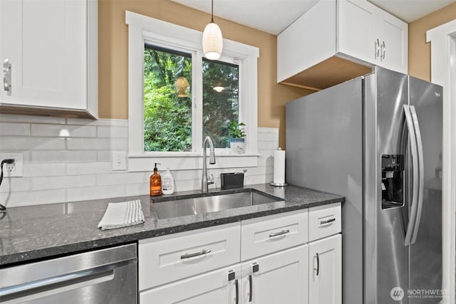 17627 17th Dr SE, Bothell, WA 98012 - kitchen featuring stainless steel appliances, white cabinets, backsplash, dark stone counters, and pendant lighting
