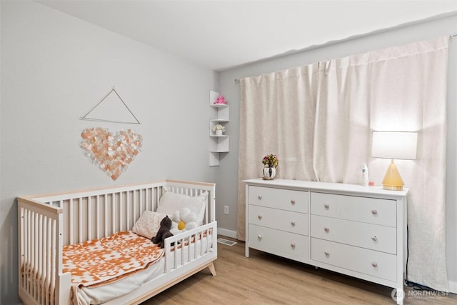 17627 17th Dr SE, Bothell, WA 98012 - bedroom with a crib and light wood-style flooring