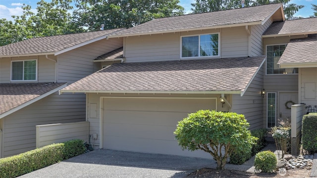 16159 SE 33rd Cir Unit 603, Bellevue, WA 98008 - view of front facade with a garage, concrete driveway, and a shingled roof
