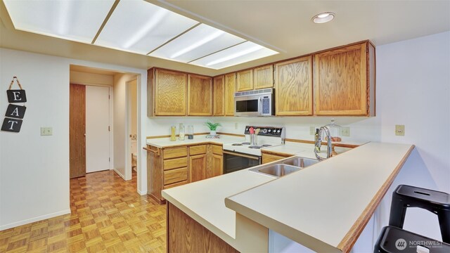 16159 SE 33rd Cir Unit 603, Bellevue, WA 98008 - kitchen with white electric range, stainless steel microwave, a peninsula, light countertops, and recessed lighting