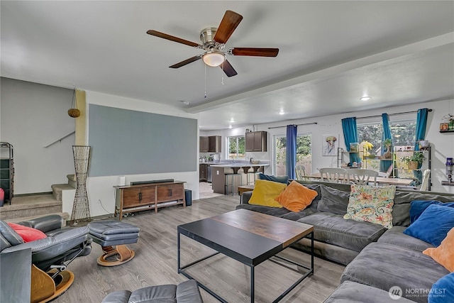 13218 197th St E, Graham, WA 98338 - living room featuring a ceiling fan, light wood-style flooring, and stairs