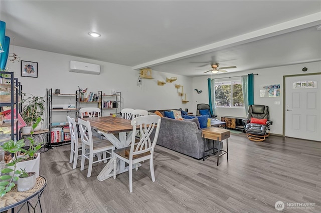 13218 197th St E, Graham, WA 98338 - dining room with wood finished floors, a ceiling fan, and a wall mounted air conditioner