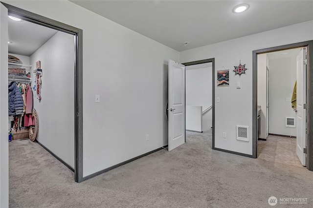 13218 197th St E, Graham, WA 98338 - unfurnished bedroom featuring light carpet, a walk in closet, and a closet