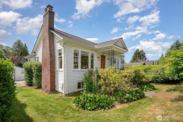 515 N 122nd St, Seattle, WA 98133 - view of home's exterior with a chimney and a yard