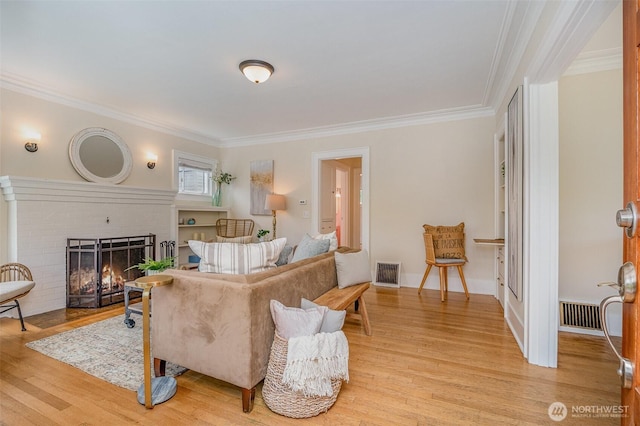 515 N 122nd St, Seattle, WA 98133 - living area with ornamental molding, light wood-style flooring, and a fireplace