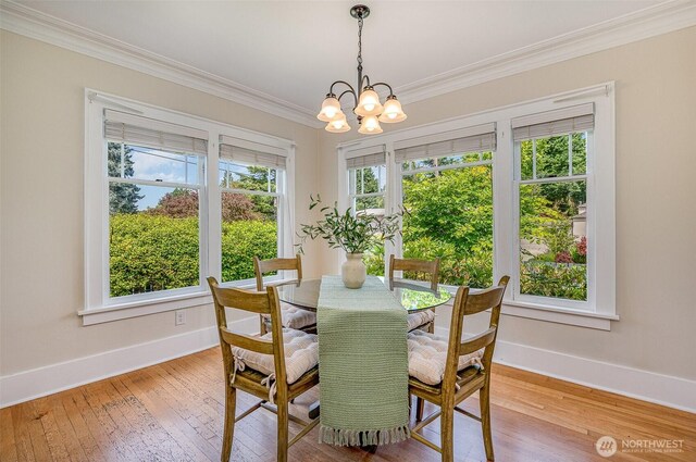 515 N 122nd St, Seattle, WA 98133 - dining space featuring ornamental molding, plenty of natural light, light wood-style flooring, and a chandelier