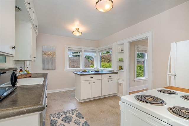 515 N 122nd St, Seattle, WA 98133 - kitchen featuring white appliances, white cabinets, and dark countertops