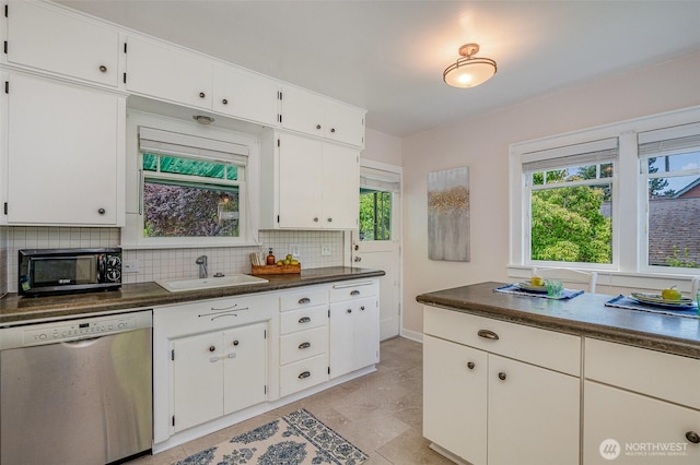 515 N 122nd St, Seattle, WA 98133 - kitchen featuring dishwasher, black microwave, tasteful backsplash, dark countertops, and white cabinets