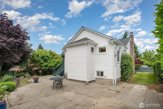 515 N 122nd St, Seattle, WA 98133 - rear view of property with a patio, a chimney, and stairs