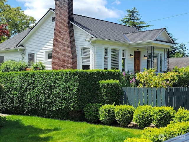 515 N 122nd St, Seattle, WA 98133 - view of side of home featuring a chimney and roof with shingles