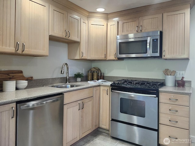 3616 23rd Ave W, Seattle, WA 98199 - kitchen featuring appliances with stainless steel finishes, light brown cabinets, and light countertops