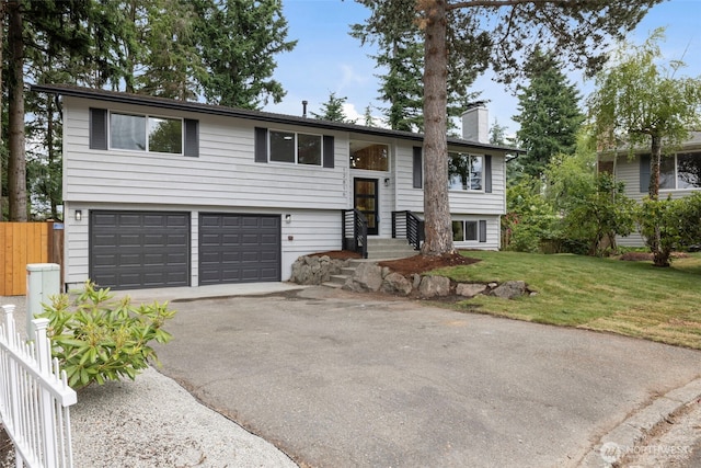 12816 SE 185th Pl, Renton, WA 98058 - raised ranch featuring asphalt driveway, a garage, and a chimney