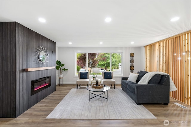 12816 SE 185th Pl, Renton, WA 98058 - living area with wood finished floors, recessed lighting, and a glass covered fireplace