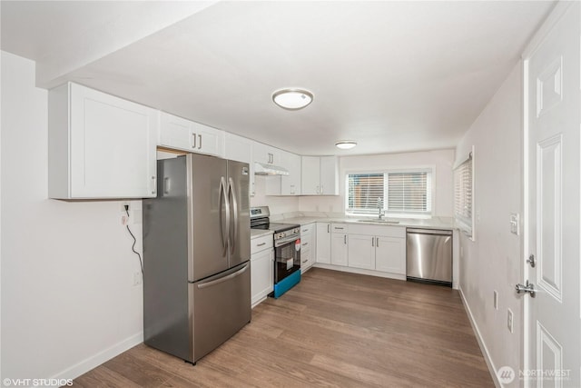18501 52nd Ave W Unit 31, Lynnwood, WA 98037 - kitchen with stainless steel appliances, under cabinet range hood, white cabinets, light countertops, and wood finished floors