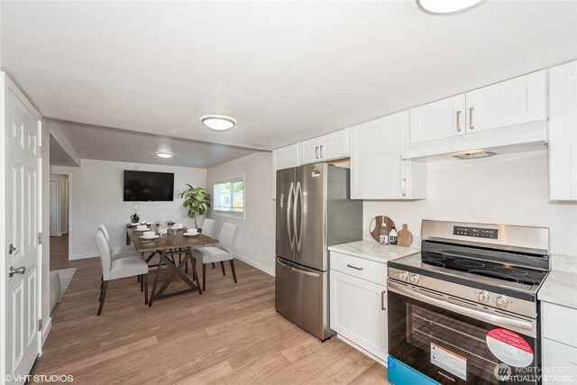 18501 52nd Ave W Unit 31, Lynnwood, WA 98037 - kitchen with appliances with stainless steel finishes, under cabinet range hood, light countertops, and light wood finished floors