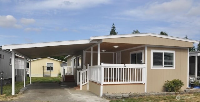 18501 52nd Ave W Unit 31, Lynnwood, WA 98037 - manufactured / mobile home featuring a porch and an attached carport