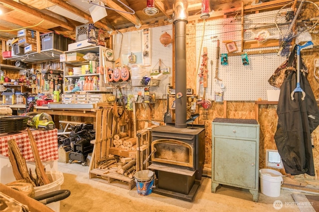 199 Ocean Blvd, Ocean Shores, WA 98569 - miscellaneous room with a workshop area, concrete flooring, and a wood stove