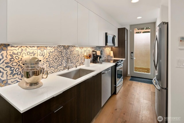 3415D Beacon Ave S, Seattle, WA 98144 - kitchen with modern cabinets, appliances with stainless steel finishes, dark brown cabinetry, light wood-style flooring, and recessed lighting