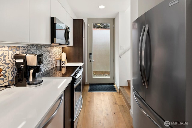 3415D Beacon Ave S, Seattle, WA 98144 - kitchen featuring stainless steel appliances, light wood-type flooring, white cabinetry, light countertops, and modern cabinets