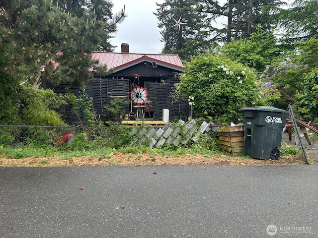 14056 31st Ave S, Seatac, WA 98168 - view of front of house featuring a chimney, a metal roof, and a standing seam roof