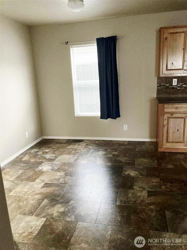 778 Elma Mccleary Rd Unit 20, Mccleary, WA 98557 - unfurnished room featuring baseboards and dark stone finish flooring