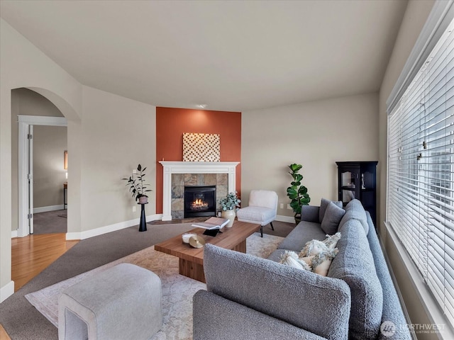 4021 220th St SE, Bothell, WA 98021 - living room featuring arched walkways, a tiled fireplace, and wood finished floors