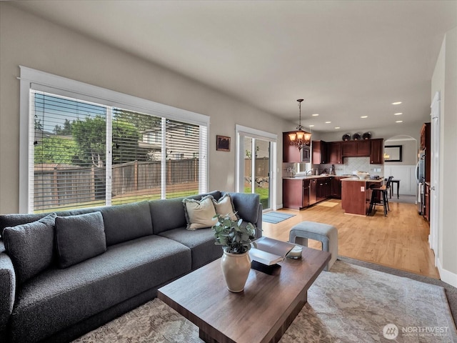 4021 220th St SE, Bothell, WA 98021 - living area featuring a chandelier, arched walkways, recessed lighting, and light wood finished floors