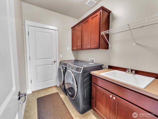 4021 220th St SE, Bothell, WA 98021 - laundry room with cabinet space, washer and clothes dryer, and light tile patterned floors