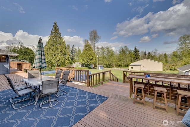 7617 160th St SE, Snohomish, WA 98296 - deck with a shed, outdoor dining area, and a lawn