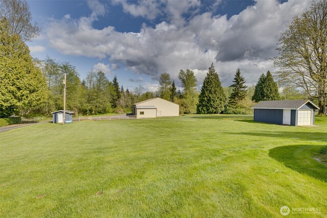 7617 160th St SE, Snohomish, WA 98296 - view of yard featuring a storage unit, an outbuilding, and view of scattered trees