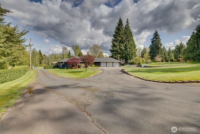 7617 160th St SE, Snohomish, WA 98296 - view of asphalt driveway with view of wooded area
