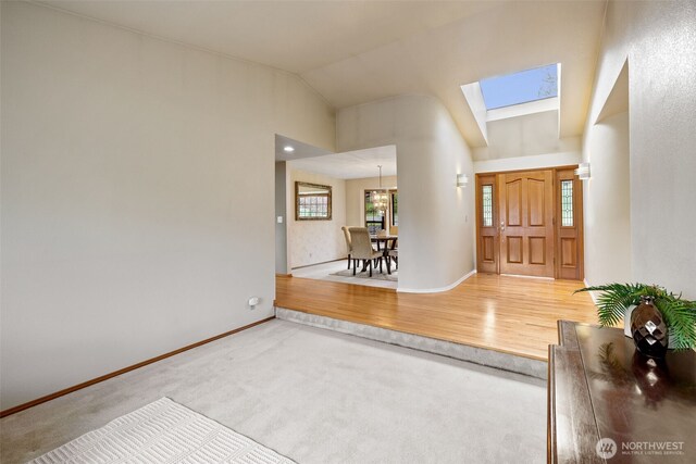 7617 160th St SE, Snohomish, WA 98296 - entryway with a skylight, lofted ceiling, carpet flooring, and wood finished floors