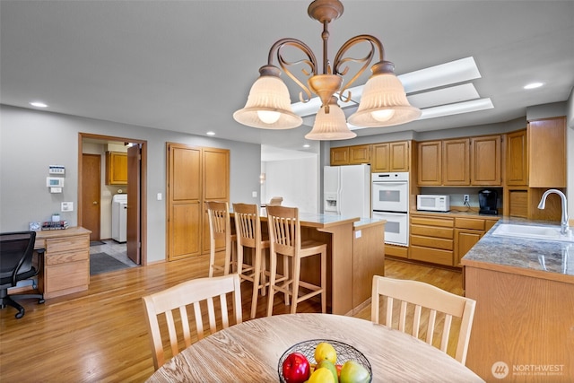7617 160th St SE, Snohomish, WA 98296 - dining room with light wood-style floors, washer / clothes dryer, recessed lighting, and a desk