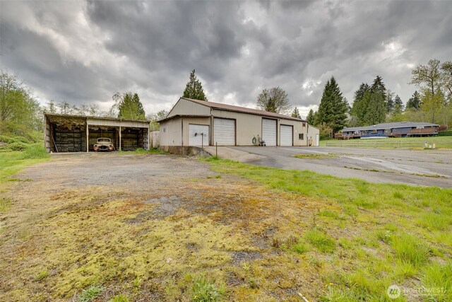 7617 160th St SE, Snohomish, WA 98296 - view of side of property featuring a garage and an outbuilding