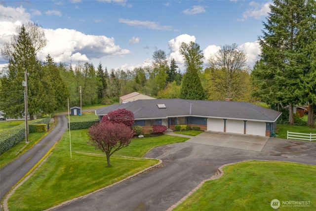 7617 160th St SE, Snohomish, WA 98296 - view of front facade featuring asphalt driveway, a garage, and a front yard